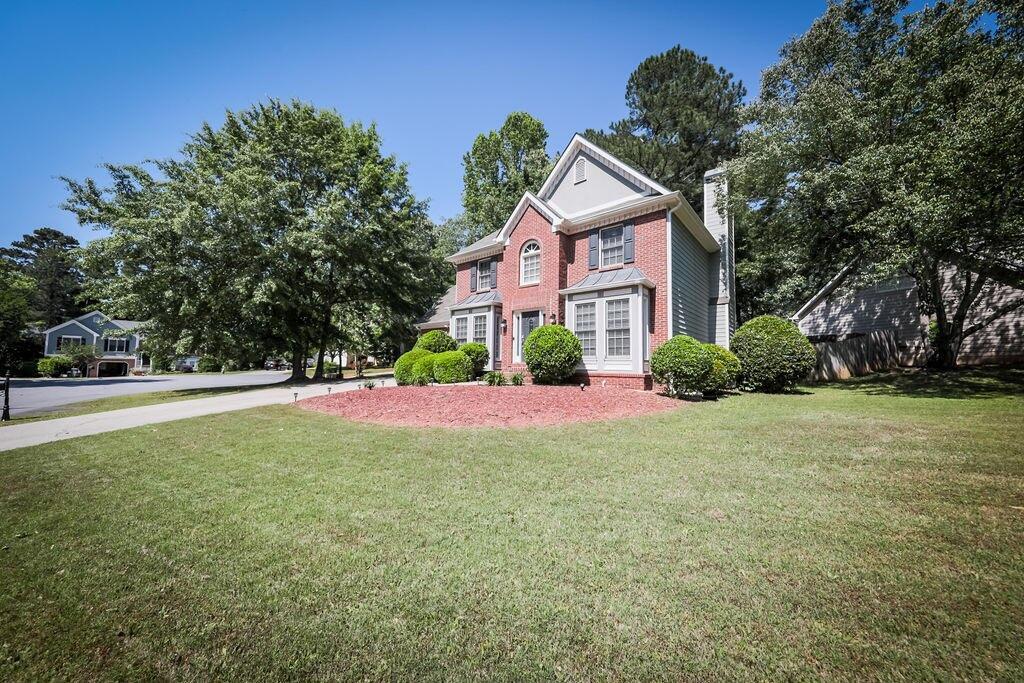 a front view of a house with a yard