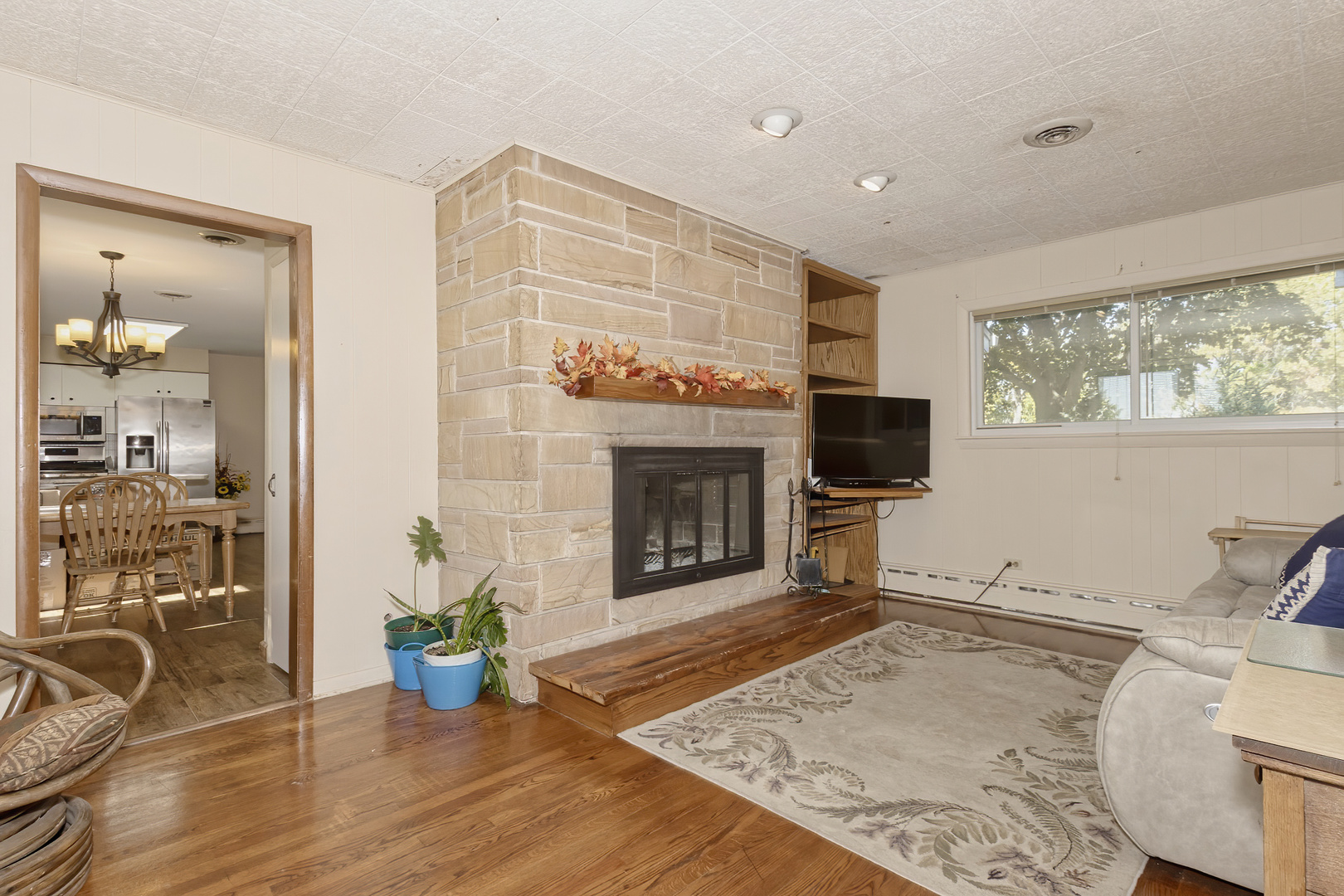3511 West Gracy Road McHenry, IL 60050 - Photo 17 of 49 a living room with furniture a flat screen tv and a fireplace