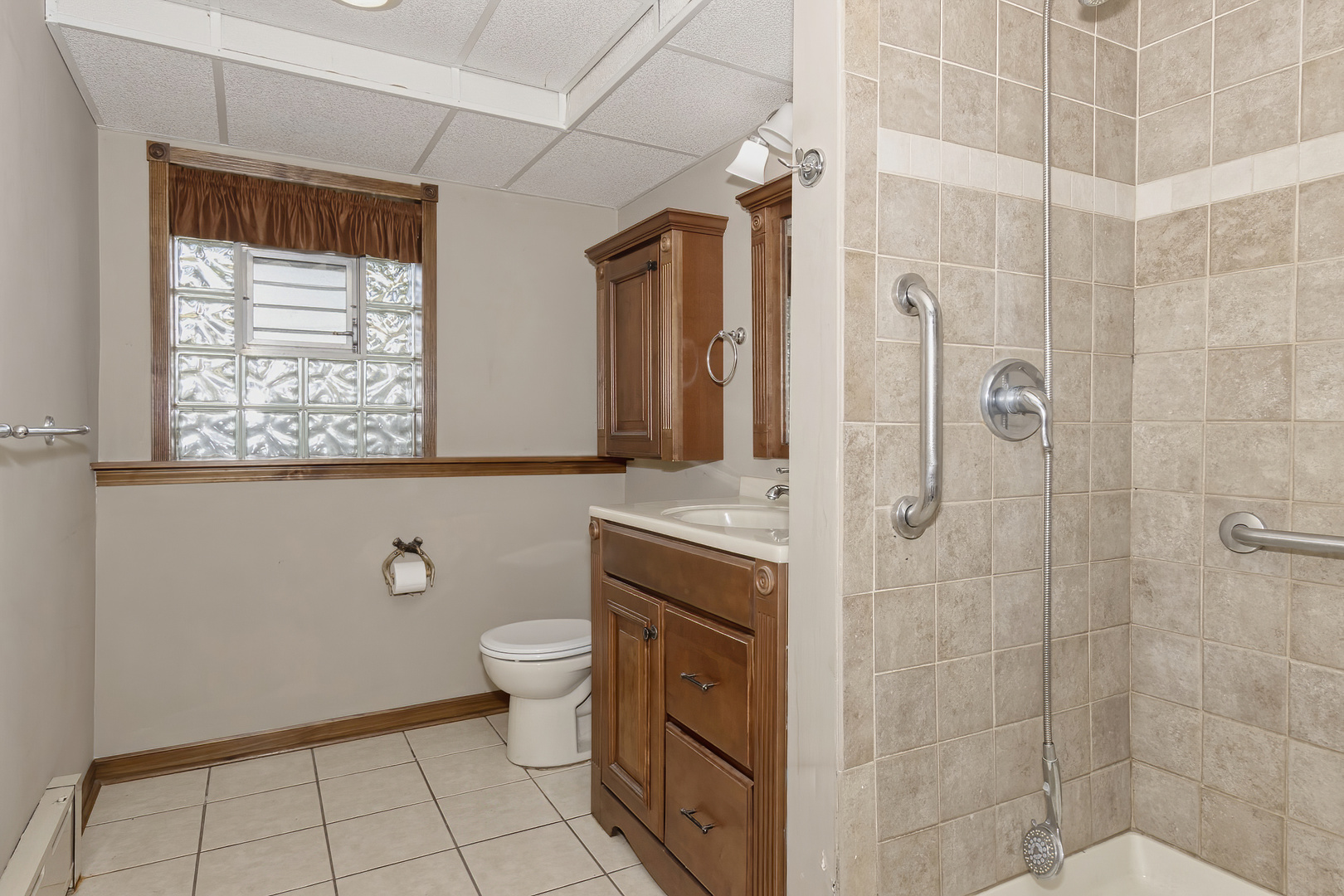 3511 West Gracy Road McHenry, IL 60050 - Photo 27 of 49 a bathroom with a granite countertop sink a toilet and shower