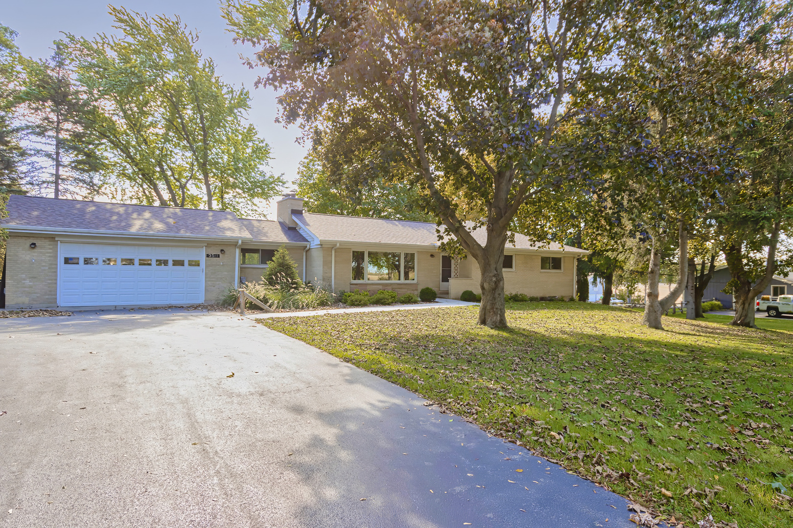 3511 West Gracy Road McHenry, IL 60050 - Photo 42 of 49 a front view of a house with a yard and garage
