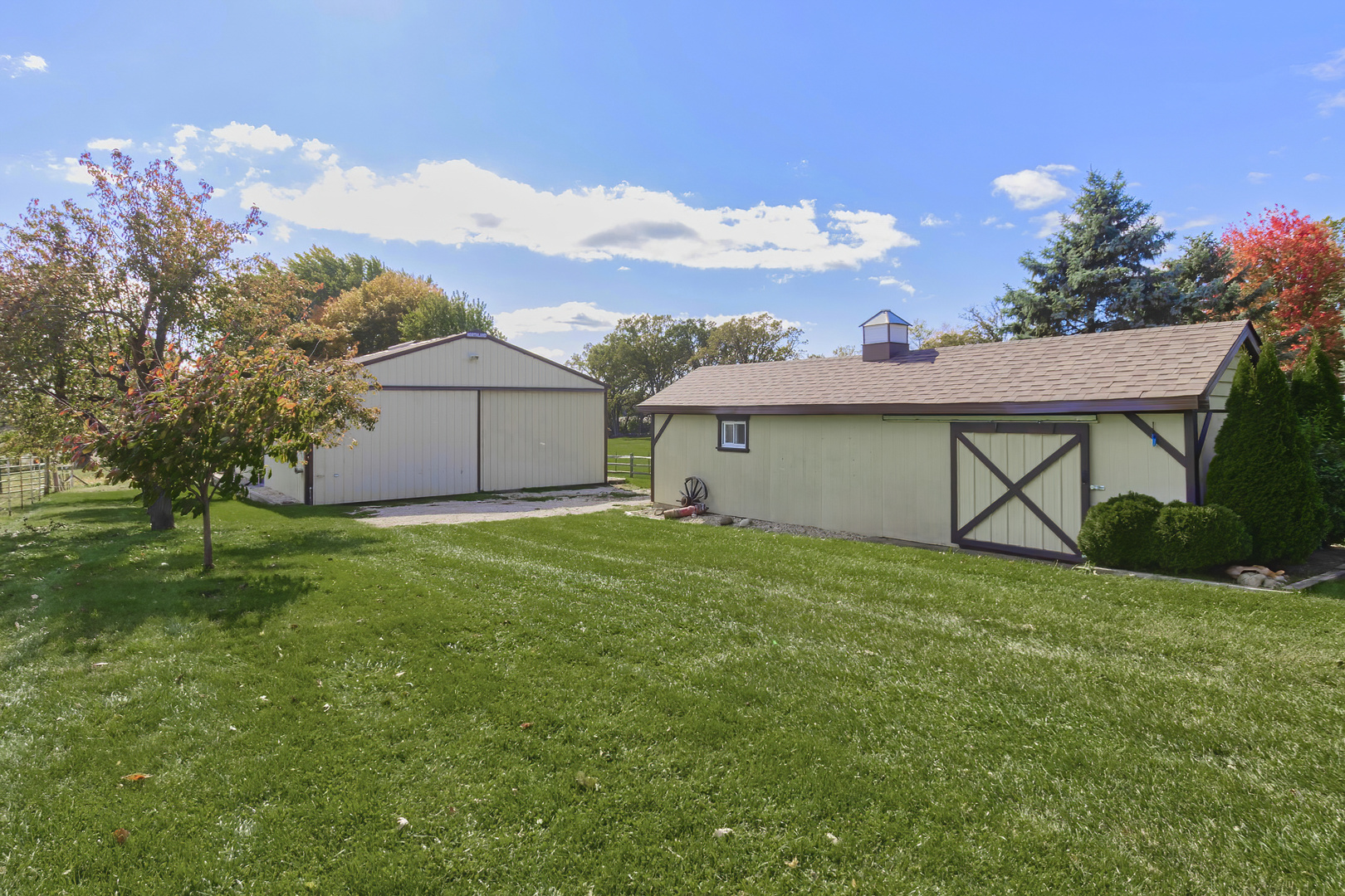 3511 West Gracy Road McHenry, IL 60050 - Photo 6 of 49 a view of a backyard with potted plants and a large tree