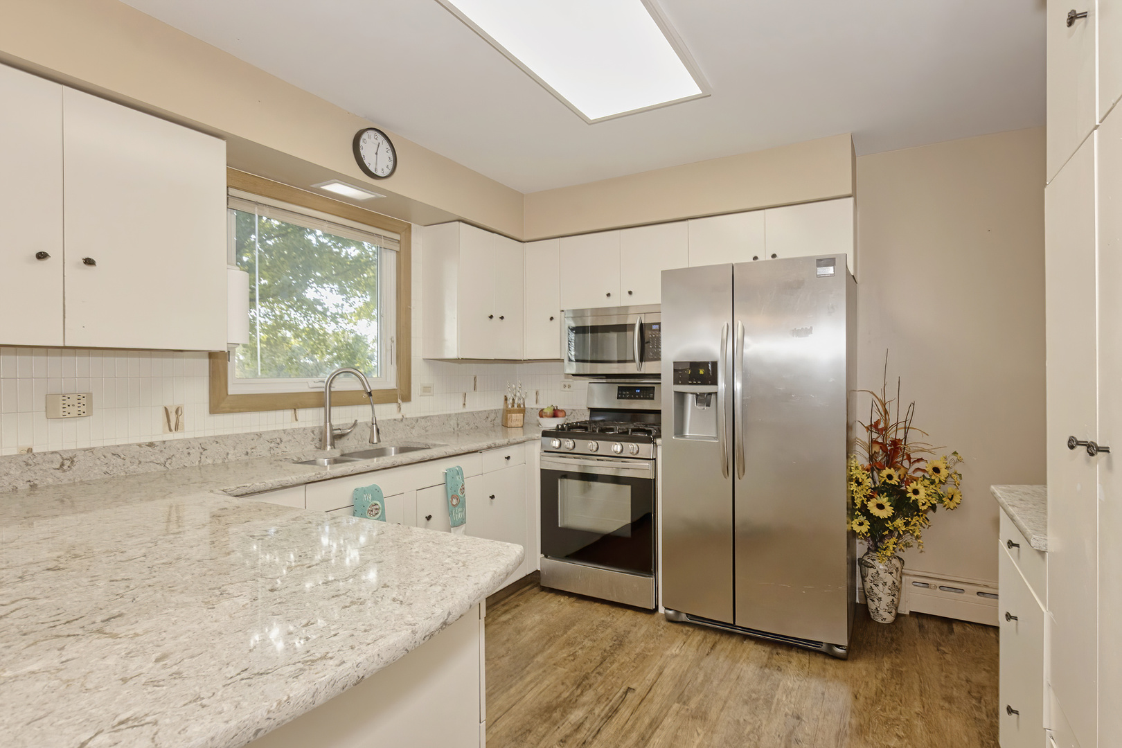 3511 West Gracy Road McHenry, IL 60050 - Photo 8 of 49 a kitchen with stainless steel appliances granite countertop a refrigerator a sink a stove a microwave and island