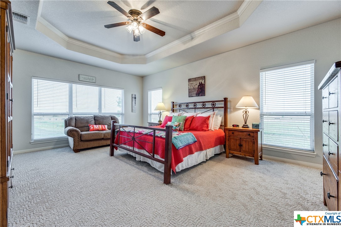 8177 Boenig Road Seguin, TX 78155 - Photo 11 of 21 a spacious bedroom with a bed and a chandelier