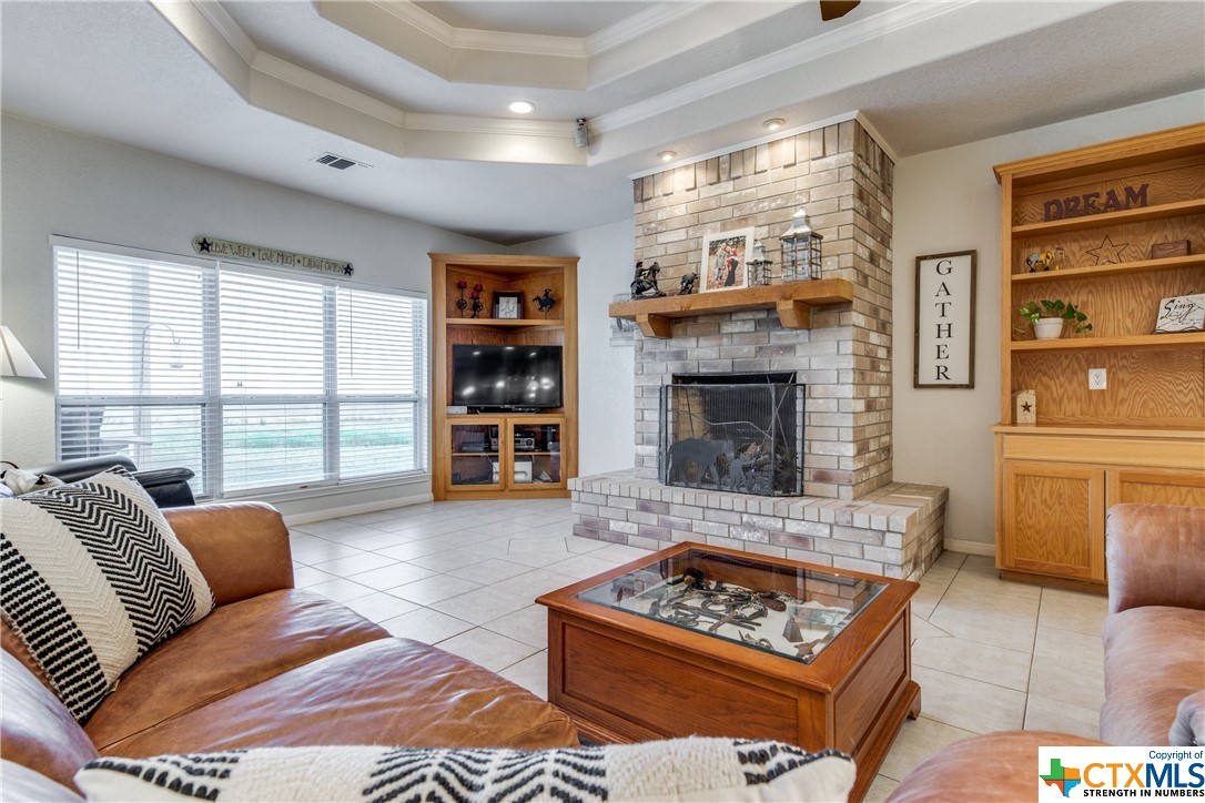 8177 Boenig Road Seguin, TX 78155 - Photo 2 of 21 a living room with furniture a rug a fireplace and a window