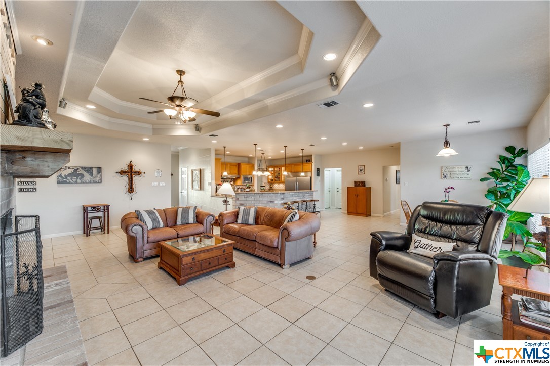 8177 Boenig Road Seguin, TX 78155 - Photo 3 of 21 a living room with furniture and a chandelier