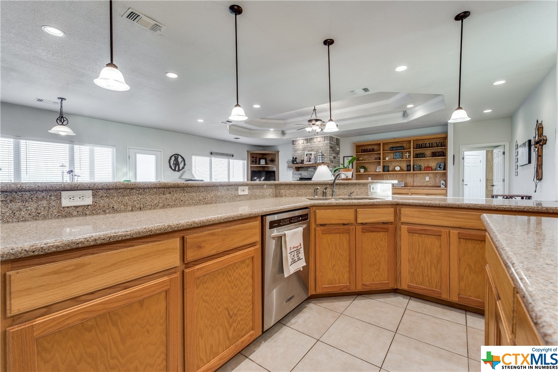 8177 Boenig Road Seguin, TX 78155 - Photo 6 of 21 a kitchen with stainless steel appliances granite countertop a sink a stove and a wooden floors