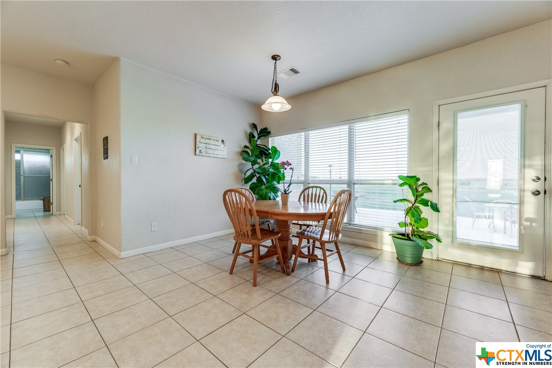 8177 Boenig Road Seguin, TX 78155 - Photo 7 of 21 a dining room filled a chandelier and kitchen view