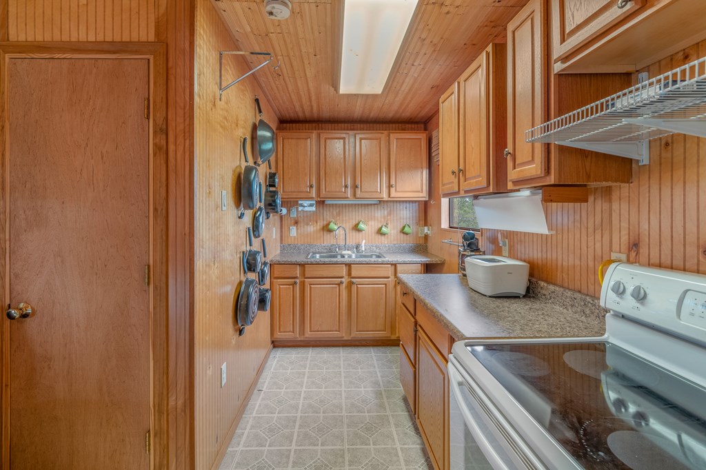 932 Shin Oak Road Menard, TX 76859 - Photo 12 of 23 a kitchen with stainless steel appliances granite countertop a sink stove and refrigerator