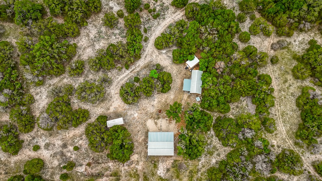 932 Shin Oak Road Menard, TX 76859 - Photo 5 of 23 an aerial view of residential house with outdoor space and trees all around