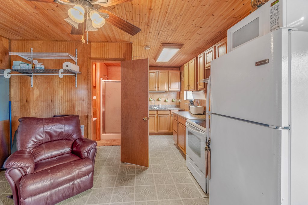 932 Shin Oak Road Menard, TX 76859 - Photo 9 of 23 a kitchen with a refrigerator and white cabinets