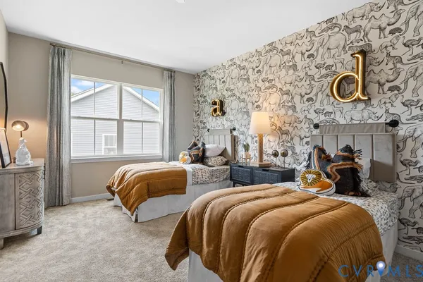 a bedroom with two beds and painting on the wall