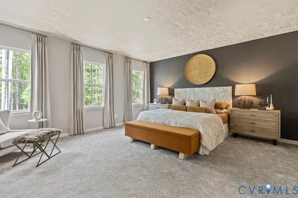 a bedroom with bed and wooden floor