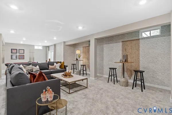 a room with pool table and windows