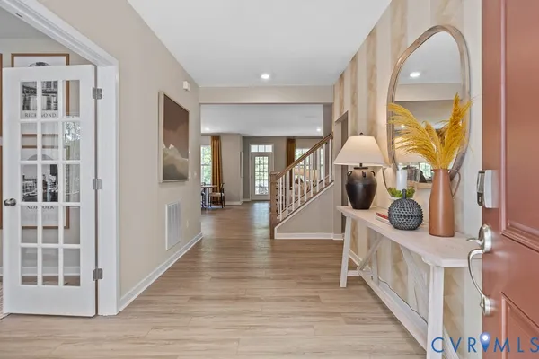 a view of a hallway view with wooden floor and windows