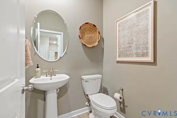 a bathroom with a toilet a sink and a mirror