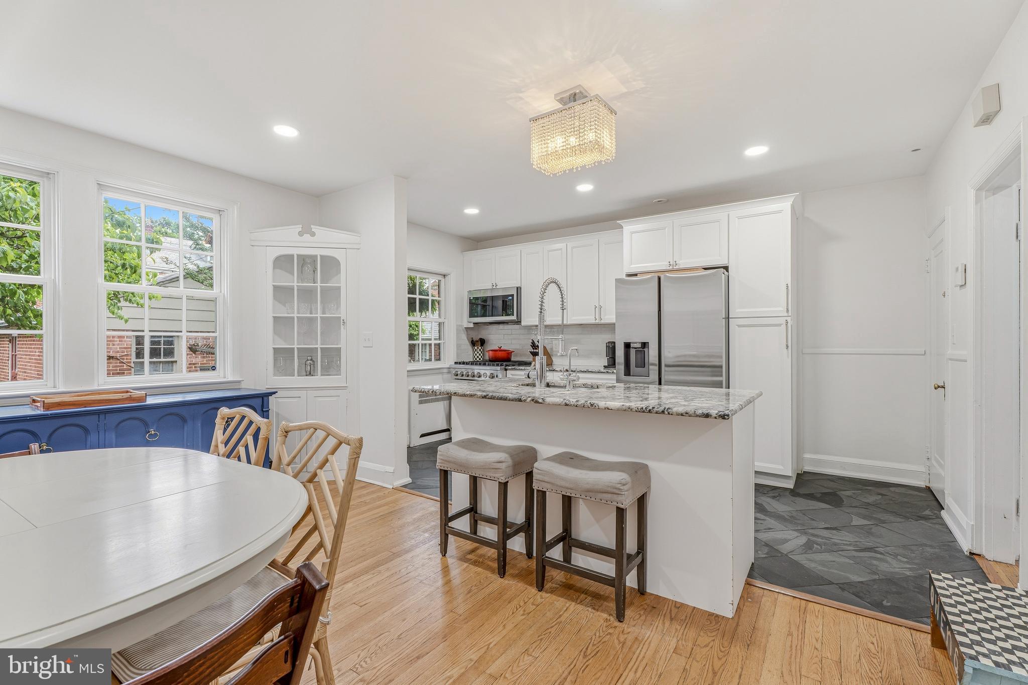 314 Murdock Road Baltimore, MD 21212 - Photo 7 of 42 a kitchen with kitchen island a large window a sink and chairs