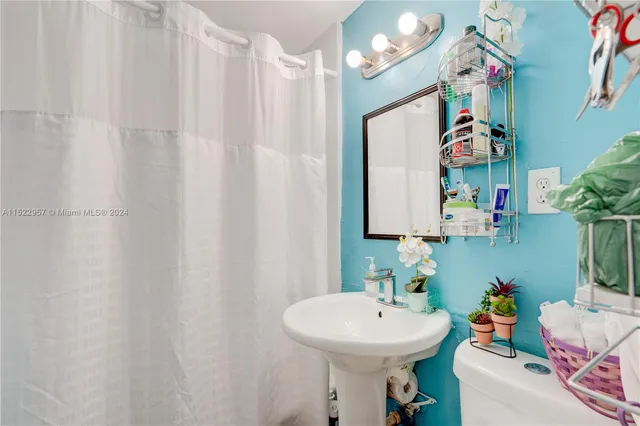 a white toilet sitting next to a bathroom sink