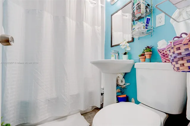 a living room with furniture a rug and a floor to ceiling window