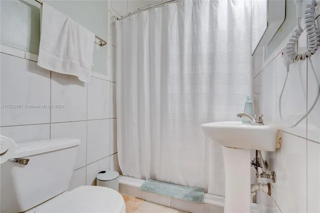 a white refrigerator freezer and a wooden floor