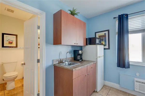 a bedroom with a bed and a lamp on desk