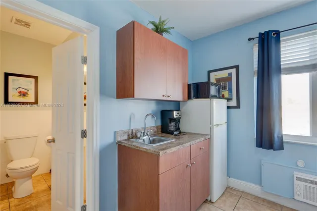 a bedroom with a bed and a lamp on desk