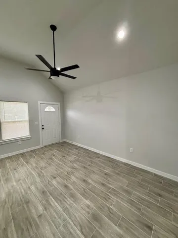 a view of a livingroom with a dishwasher cabinets and a wooden floor