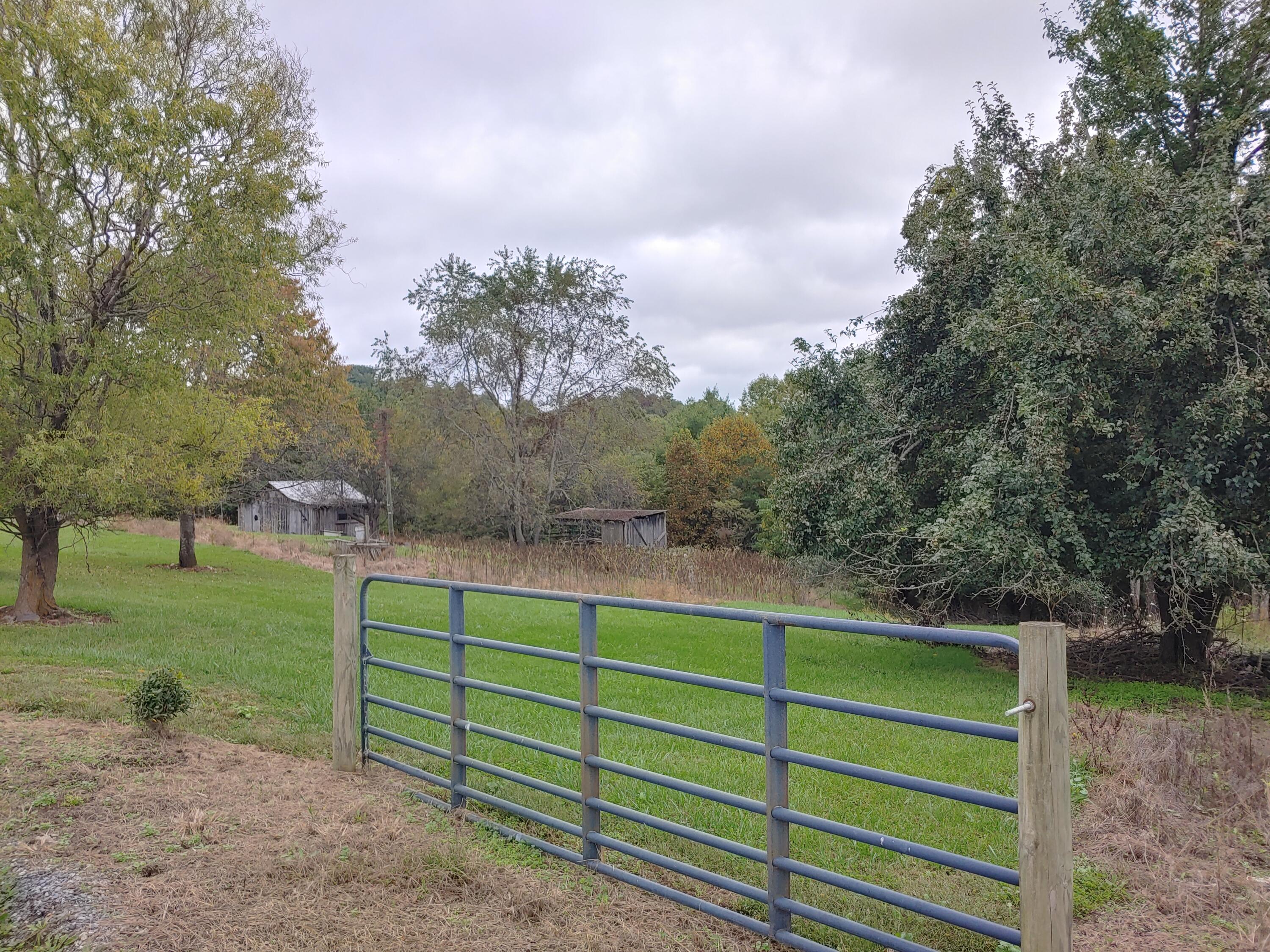 599 Otey Road Northeast Riner, VA 24149 - Photo 5 of 9 a view of a green field with wooden fence