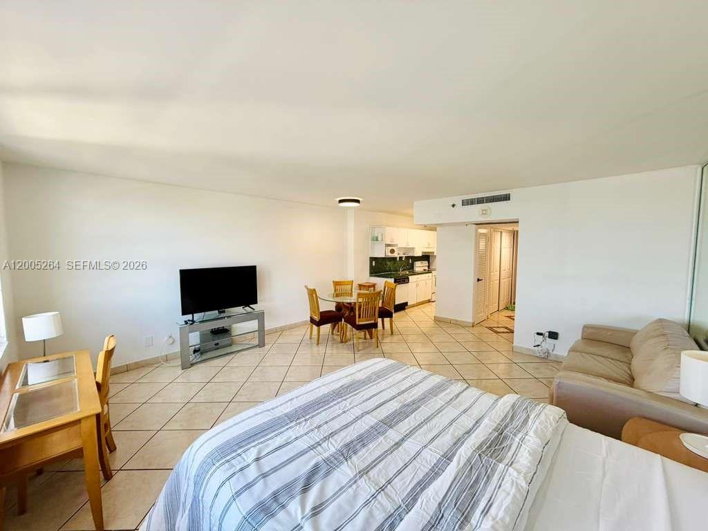 a bedroom with a bed and a flat screen tv