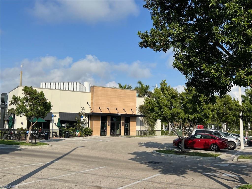 2964 Peters Avenue Naples, FL 34112 - Photo 11 of 12 a car parked in front of a building
