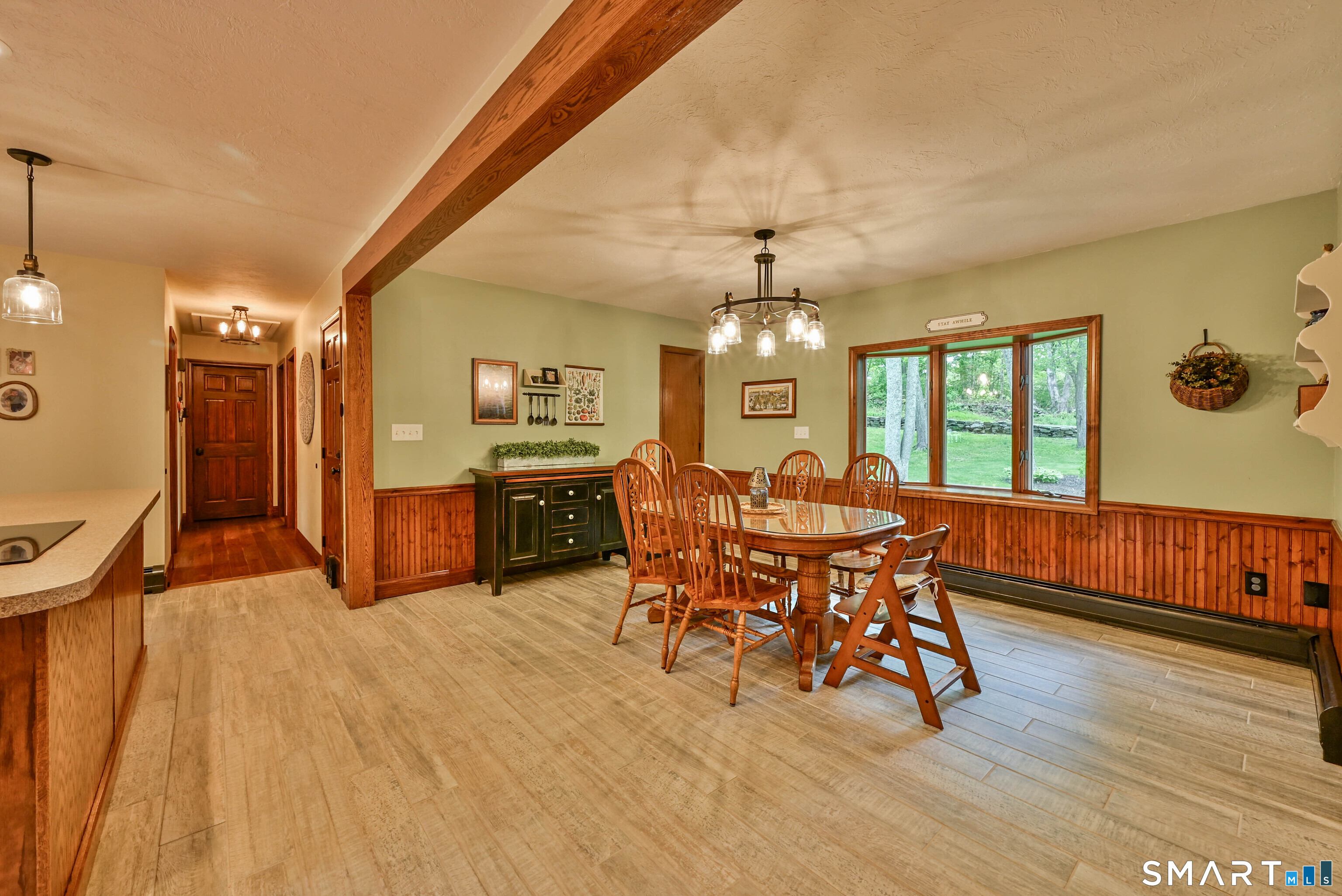 309 O'Leary Road Thompson, CT 06277 - Photo 20 of 40 a dining room with furniture a chandelier and wooden floor