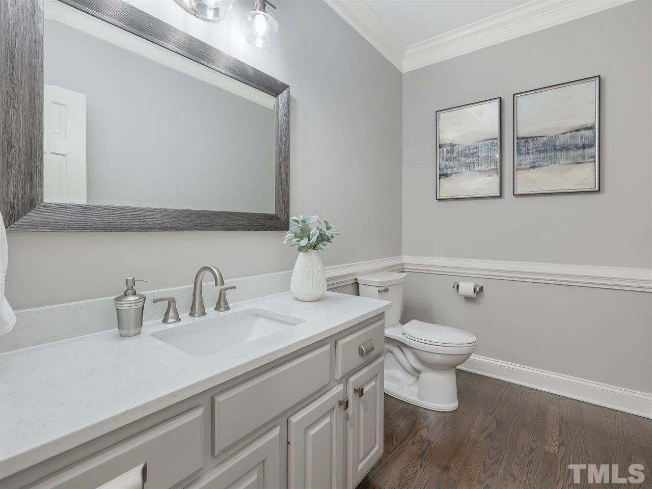104 Beech Slope Way Cary, NC 27518 - Photo 13 of 30 a bathroom with a toilet sink and mirror