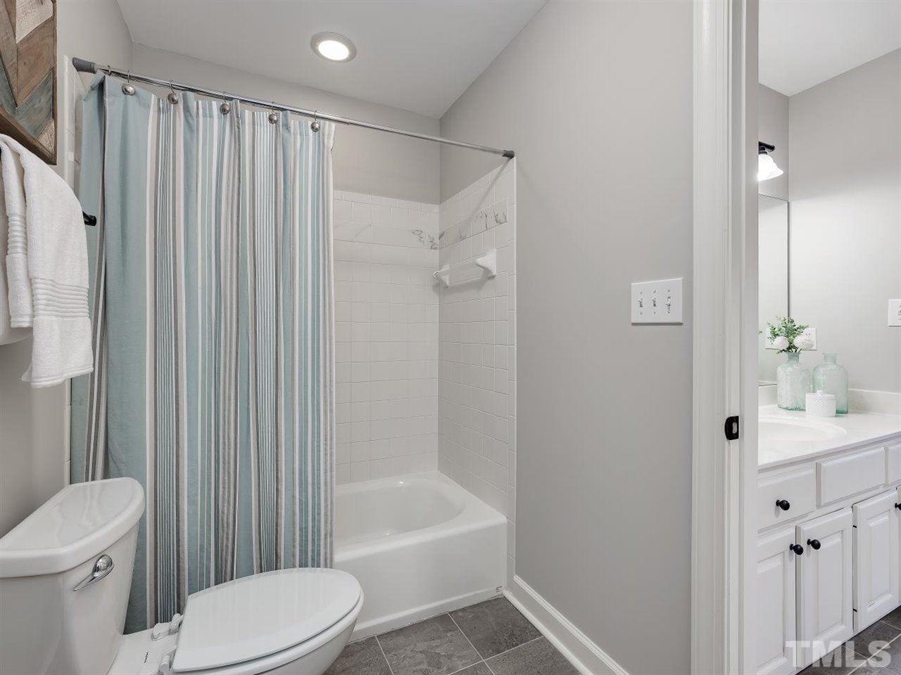 104 Beech Slope Way Cary, NC 27518 - Photo 22 of 30 a bathroom with a toilet a sink and bathtub