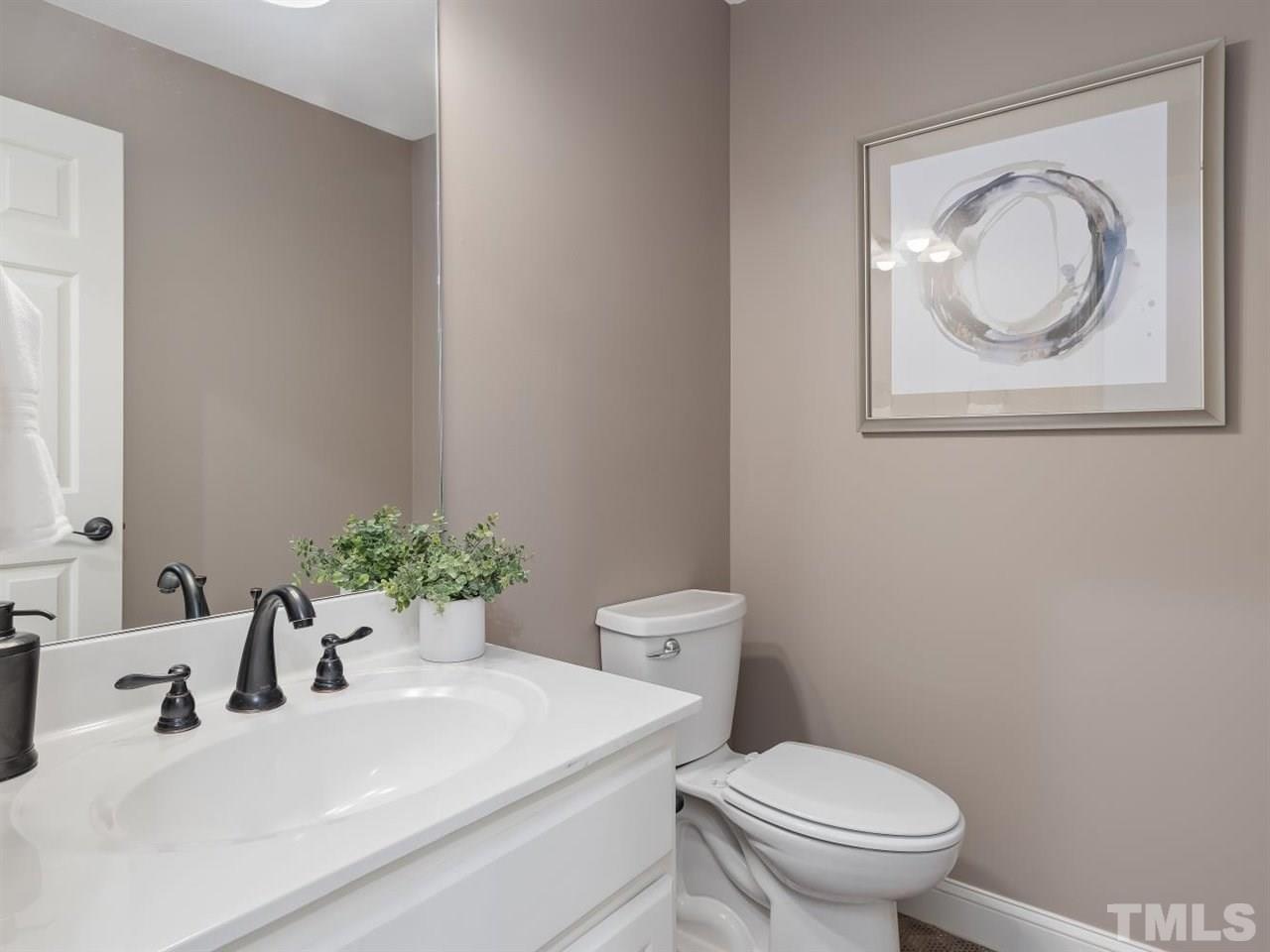 104 Beech Slope Way Cary, NC 27518 - Photo 26 of 30 a bathroom with a toilet a sink and a mirror