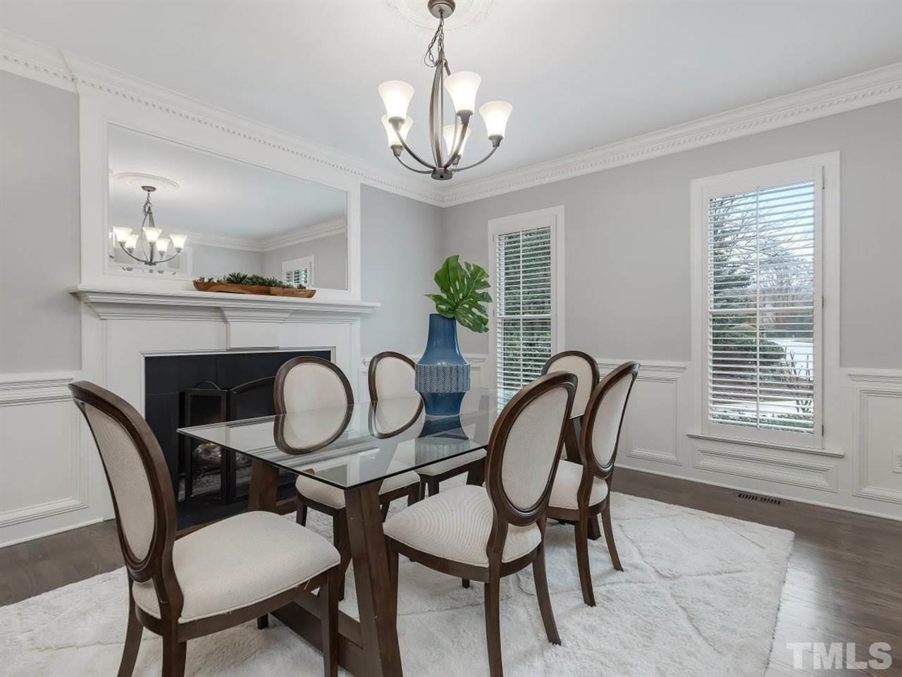 104 Beech Slope Way Cary, NC 27518 - Photo 4 of 30 a dining room with furniture a chandelier and wooden floor