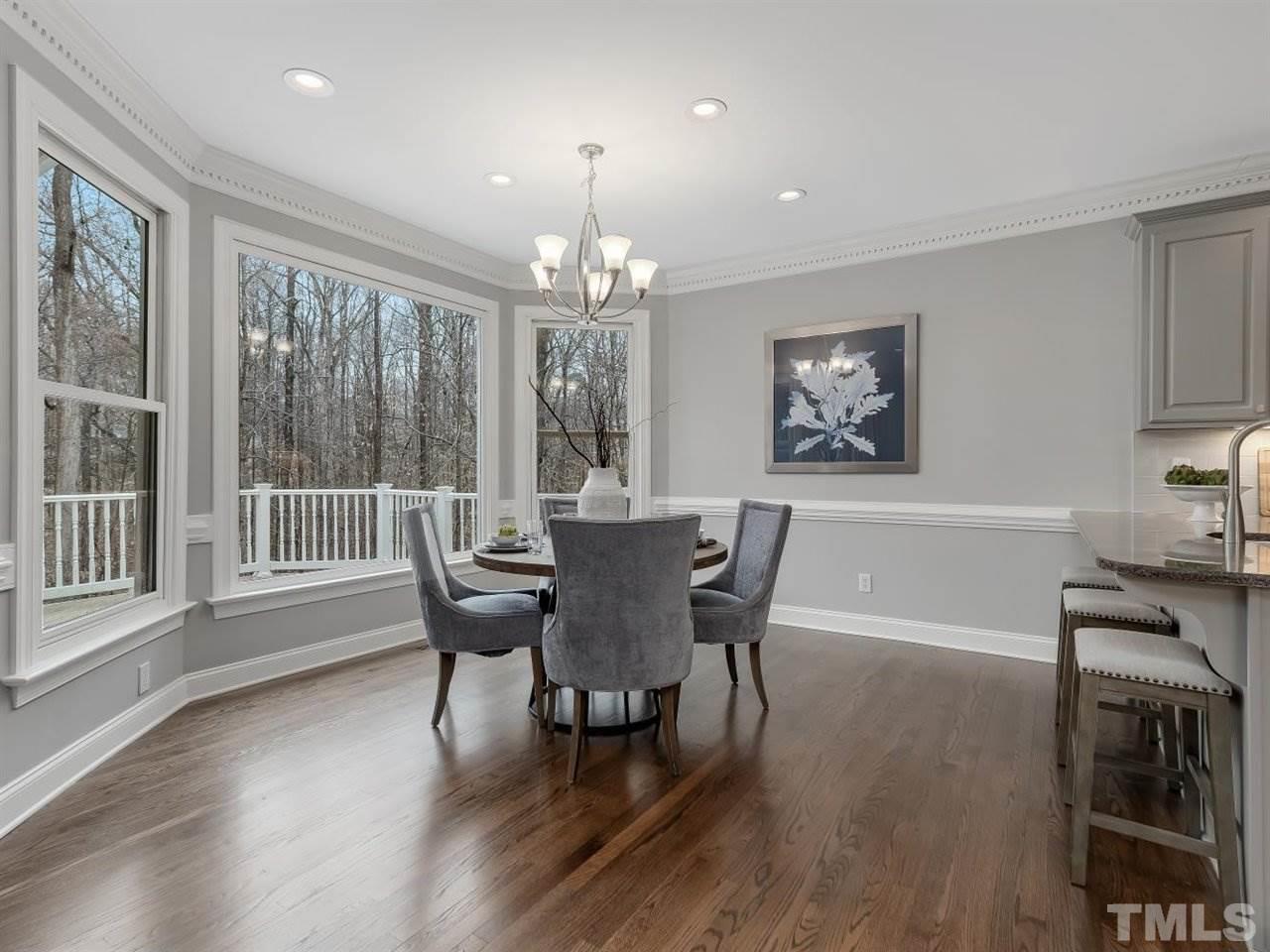 104 Beech Slope Way Cary, NC 27518 - Photo 8 of 30 a view of a dining room with furniture window and wooden floor