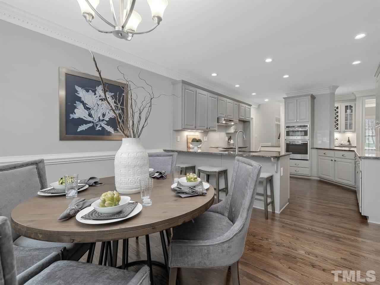 104 Beech Slope Way Cary, NC 27518 - Photo 9 of 30 a view of a dining room with furniture and wooden floor