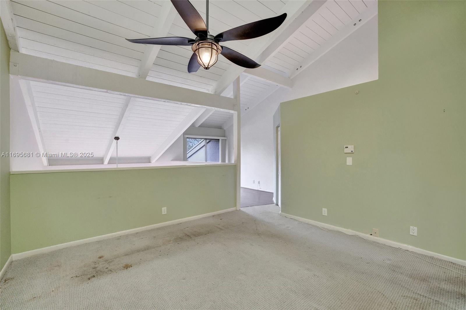 93 Northeast 17th Court, Unit 93 Fort Lauderdale, FL 33305 - Photo 29 of 43 an empty room with a ceiling fan and a window