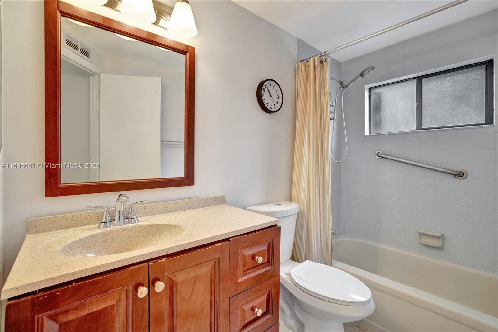 93 Northeast 17th Court, Unit 93 Fort Lauderdale, FL 33305 - Photo 42 of 43 a bathroom with a granite countertop sink toilet a mirror and shower