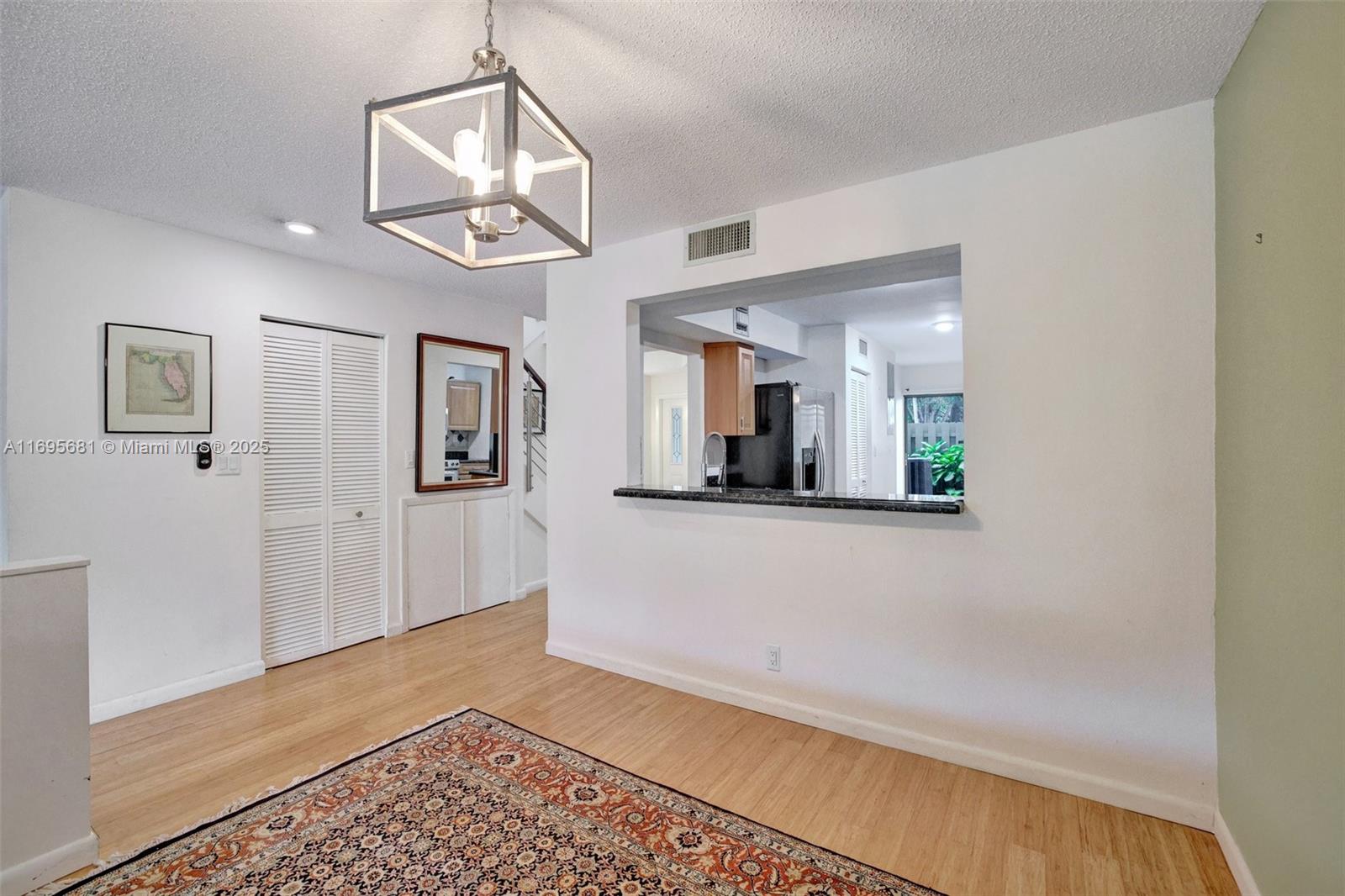 93 Northeast 17th Court, Unit 93 Fort Lauderdale, FL 33305 - Photo 8 of 43 a view of a hallway with wooden floor and cabinet