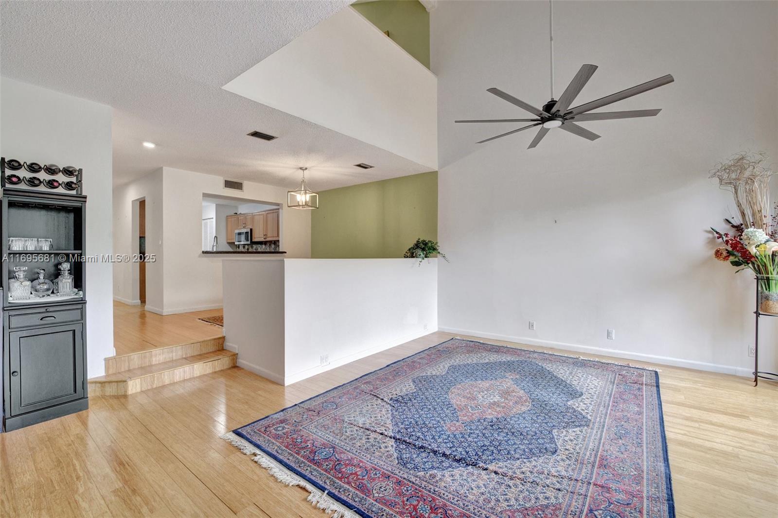 93 Northeast 17th Court, Unit 93 Fort Lauderdale, FL 33305 - Photo 9 of 43 a view of a kitchen with furniture and wooden floor