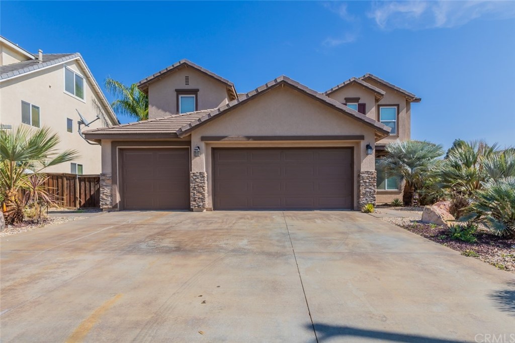 8196 Aliso Court Riverside, CA 92508 - Photo 1 of 1 a front view of a house with a yard and garage