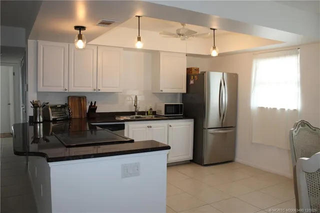a kitchen with refrigerator and window