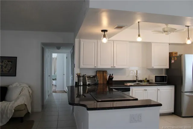 a kitchen with stainless steel appliances granite countertop a sink a stove and a refrigerator