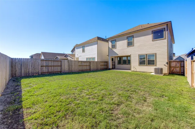 a front view of a house with a garden and yard