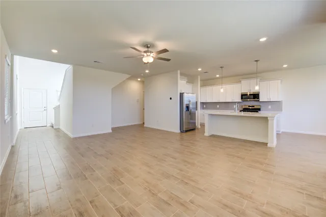 a view of a kitchen with a sink and a refrigerator