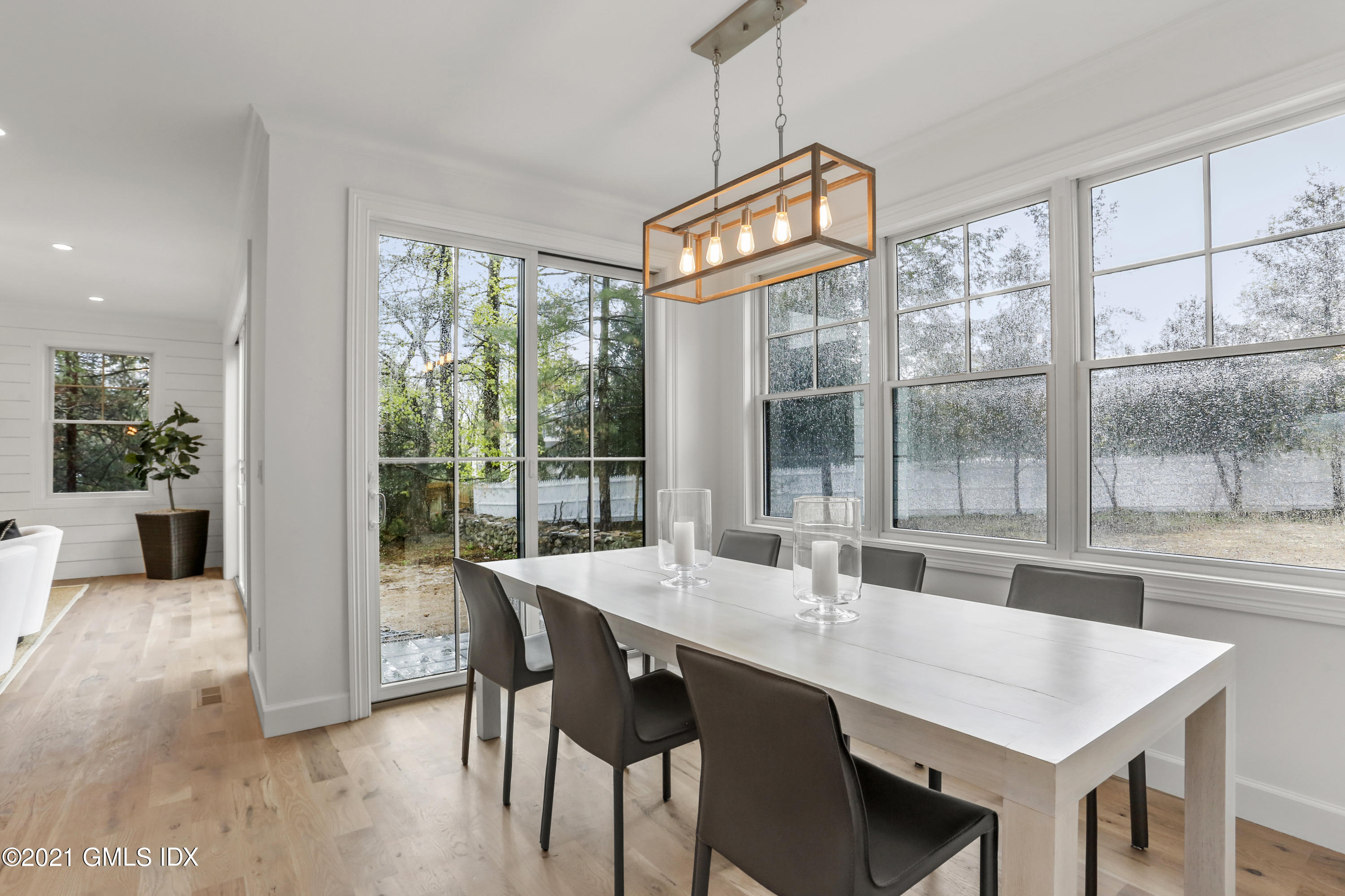 12 Cottontail Road Cos Cob, CT 06807 - Photo 12 of 35 a view of a dining room with furniture large windows and wooden floor