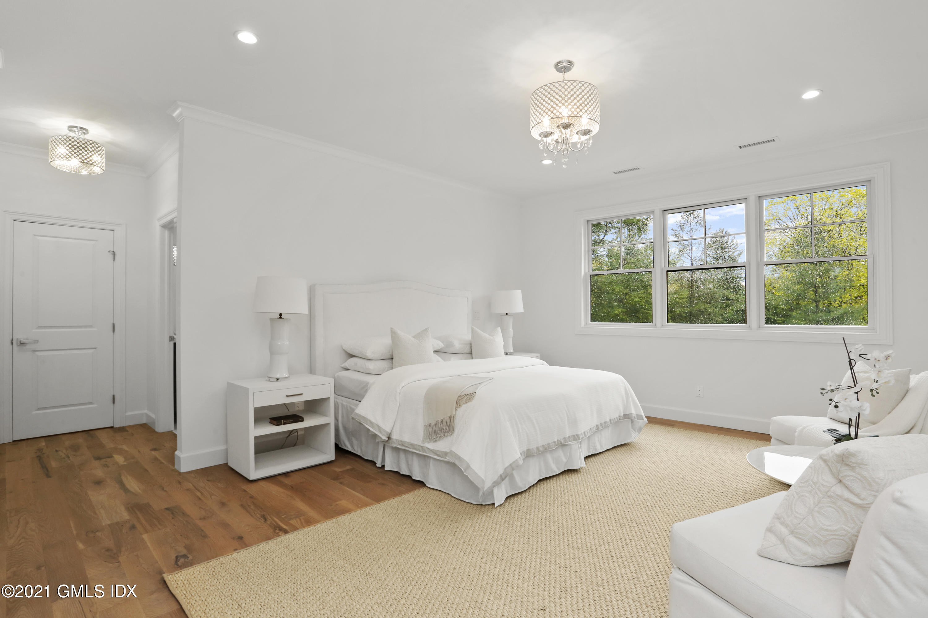 12 Cottontail Road Cos Cob, CT 06807 - Photo 14 of 35 a spacious bedroom with a bed and a chandelier