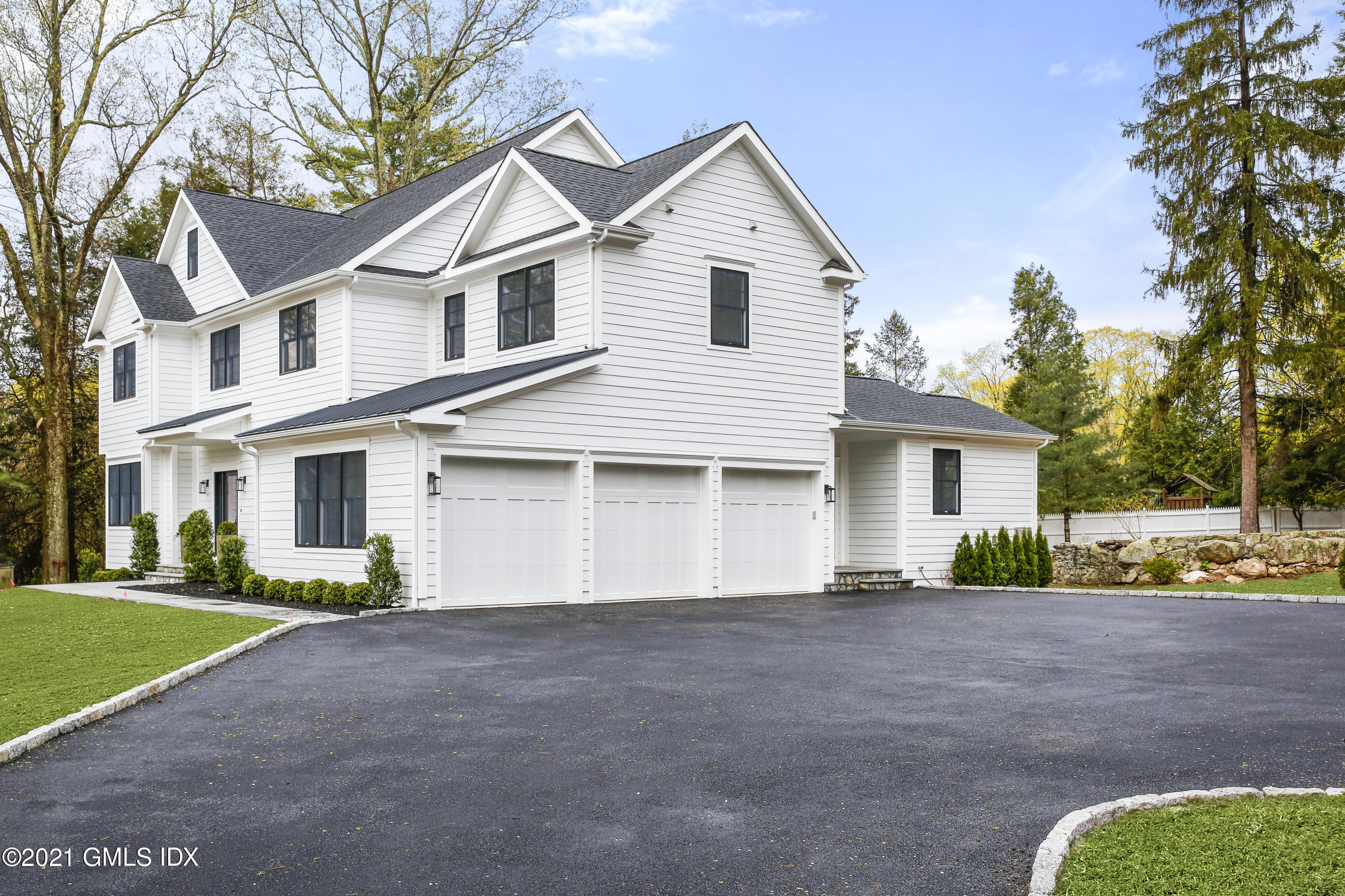 12 Cottontail Road Cos Cob, CT 06807 - Photo 26 of 35 a front view of a house with a yard and garage
