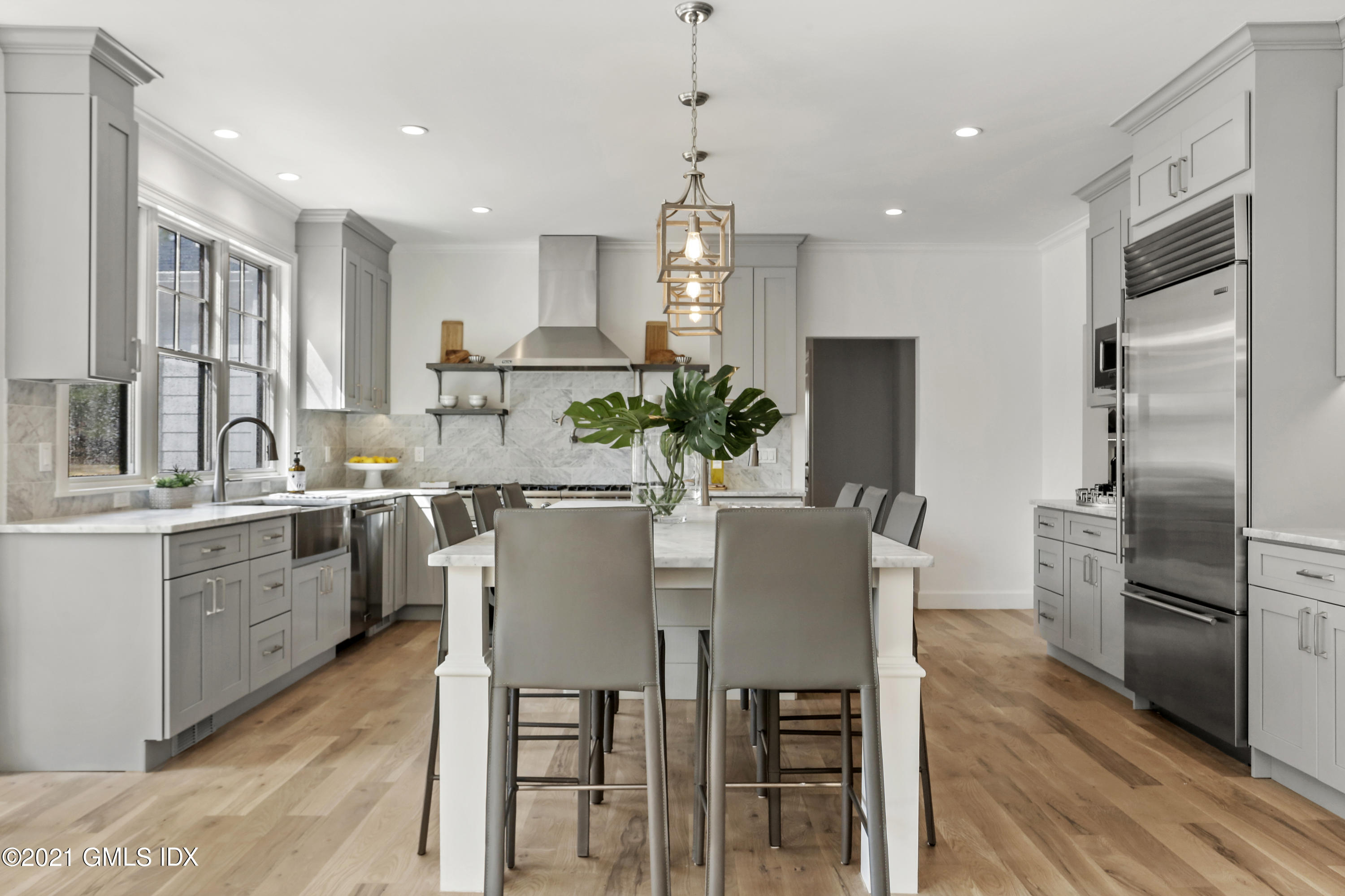 12 Cottontail Road Cos Cob, CT 06807 - Photo 3 of 35 a kitchen with refrigerator a sink and chairs