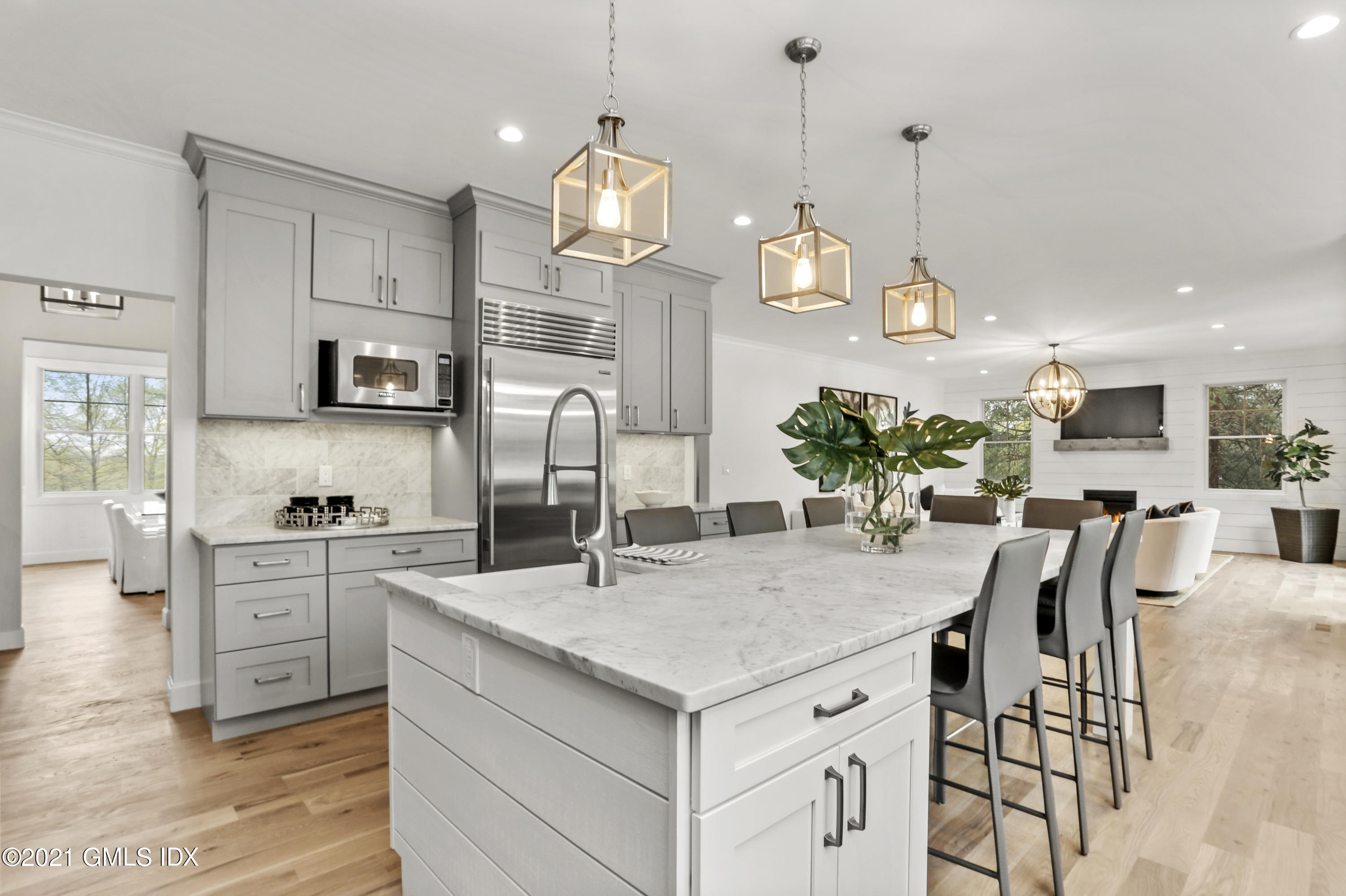 12 Cottontail Road Cos Cob, CT 06807 - Photo 9 of 35 a kitchen with kitchen island granite countertop a sink a center island and cabinets